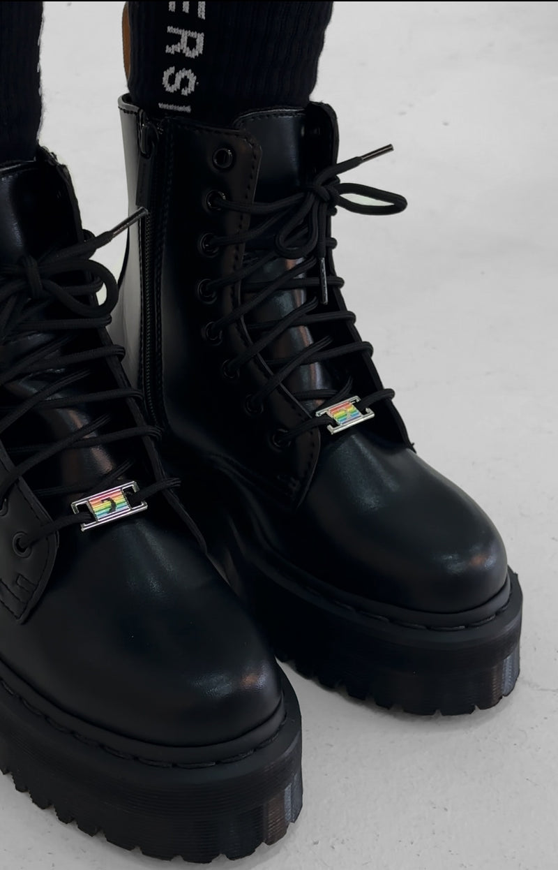 Rainbow D'Lux pins on the laces of black boots