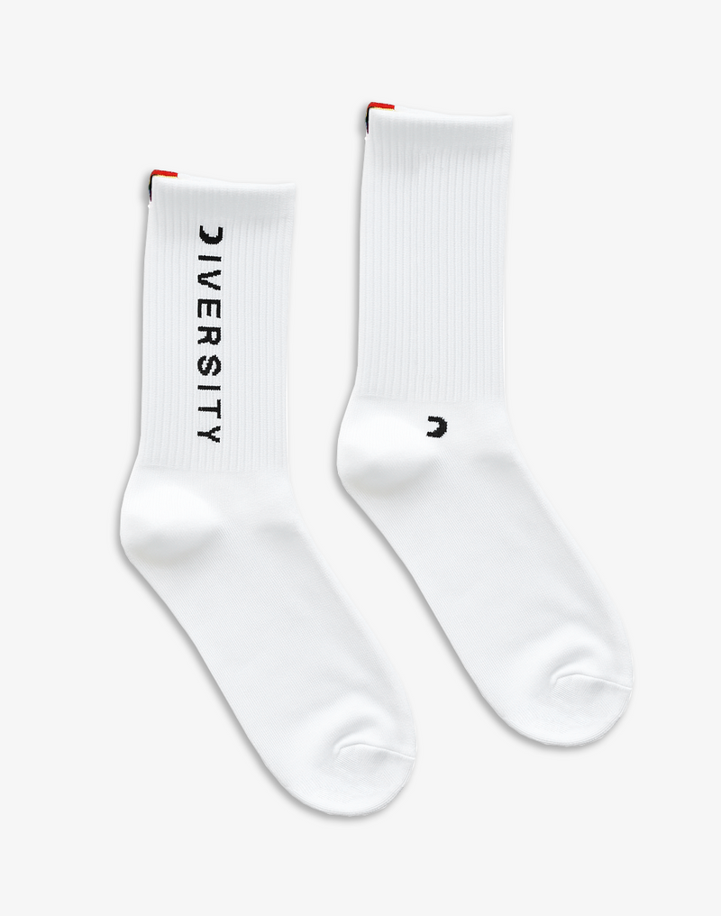 Pair of white Diversity socks laid flat, DIVERSITY logo and rainbow tag