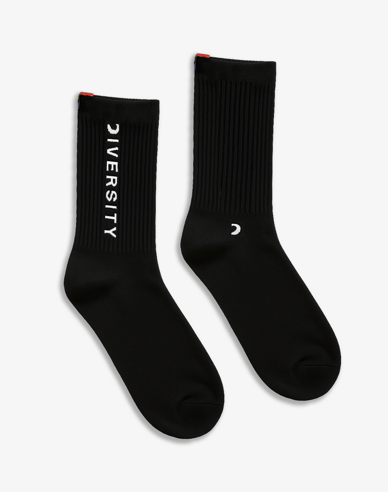 Pair of black Diversity socks laid flat, DIVERSITY logo and rainbow tag