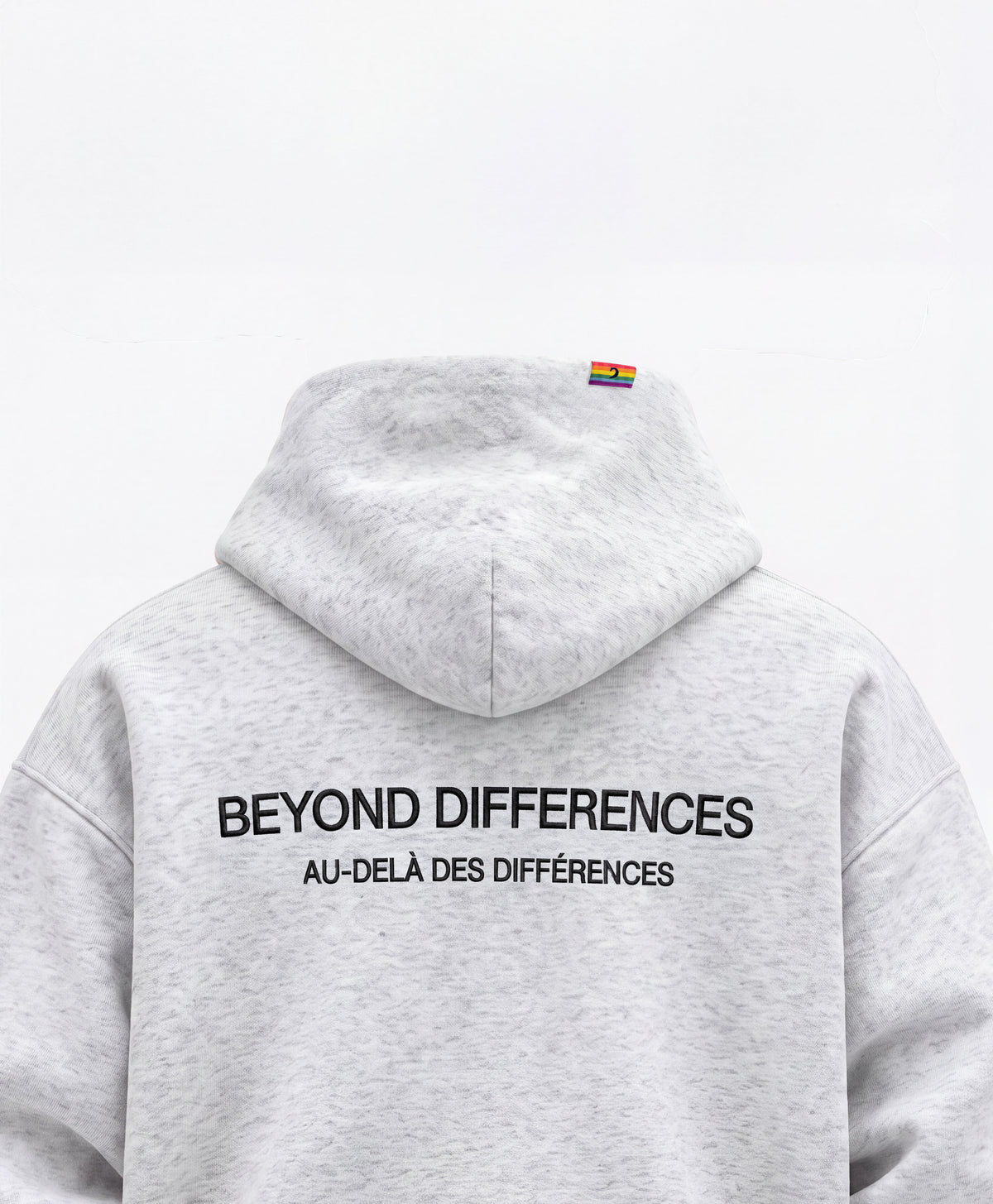 Back of the grey Heavyweight Hoodie: black BEYOND DIFFERENCES / AU-DELÀ DES DIFFÉRENCES embroidery