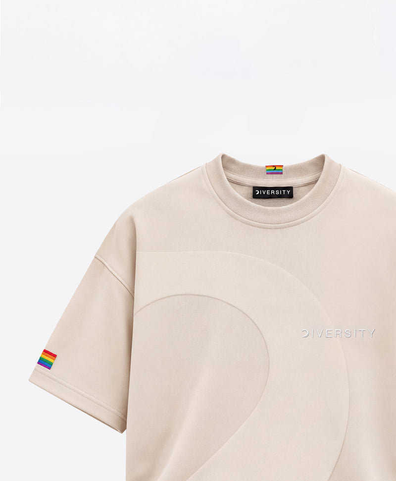 Sand Heavyweight T-shirt with a tone-on-tone curved panel, rainbow flag embroidered on the sleeve