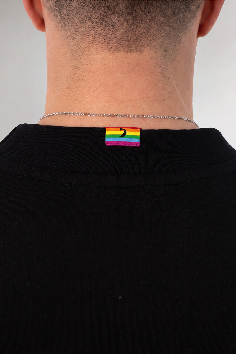 Rainbow flag tag stitched at the back collar of the black Heavyweight T-shirt