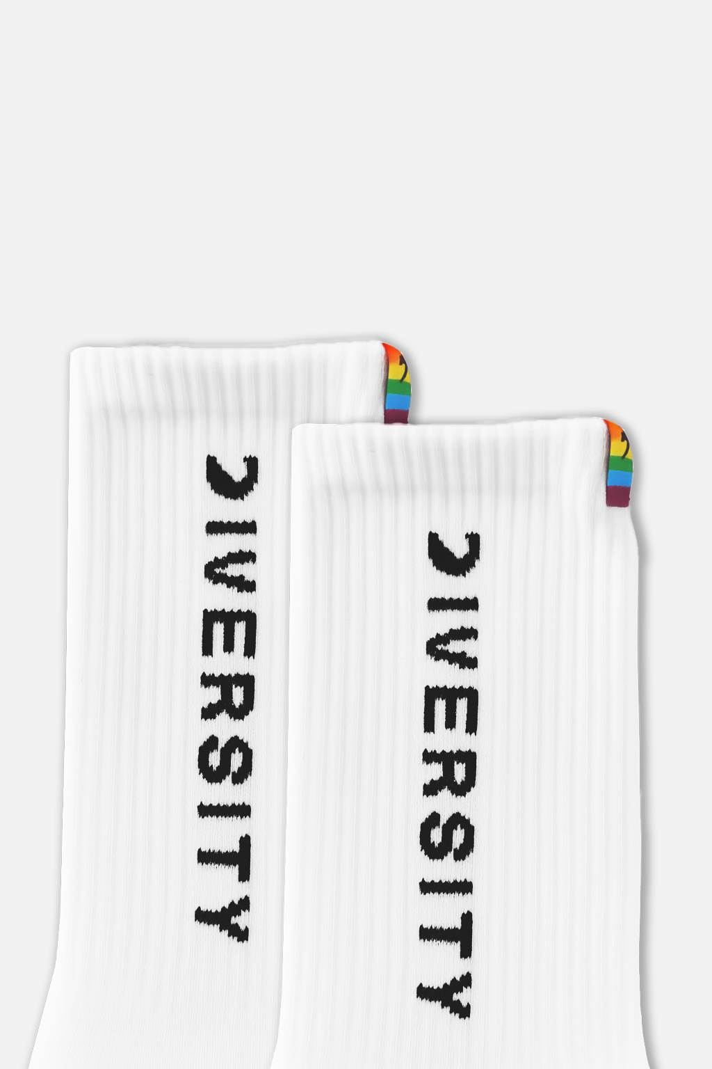 Close-up of the DIVERSITY logo and rainbow tag on the white socks