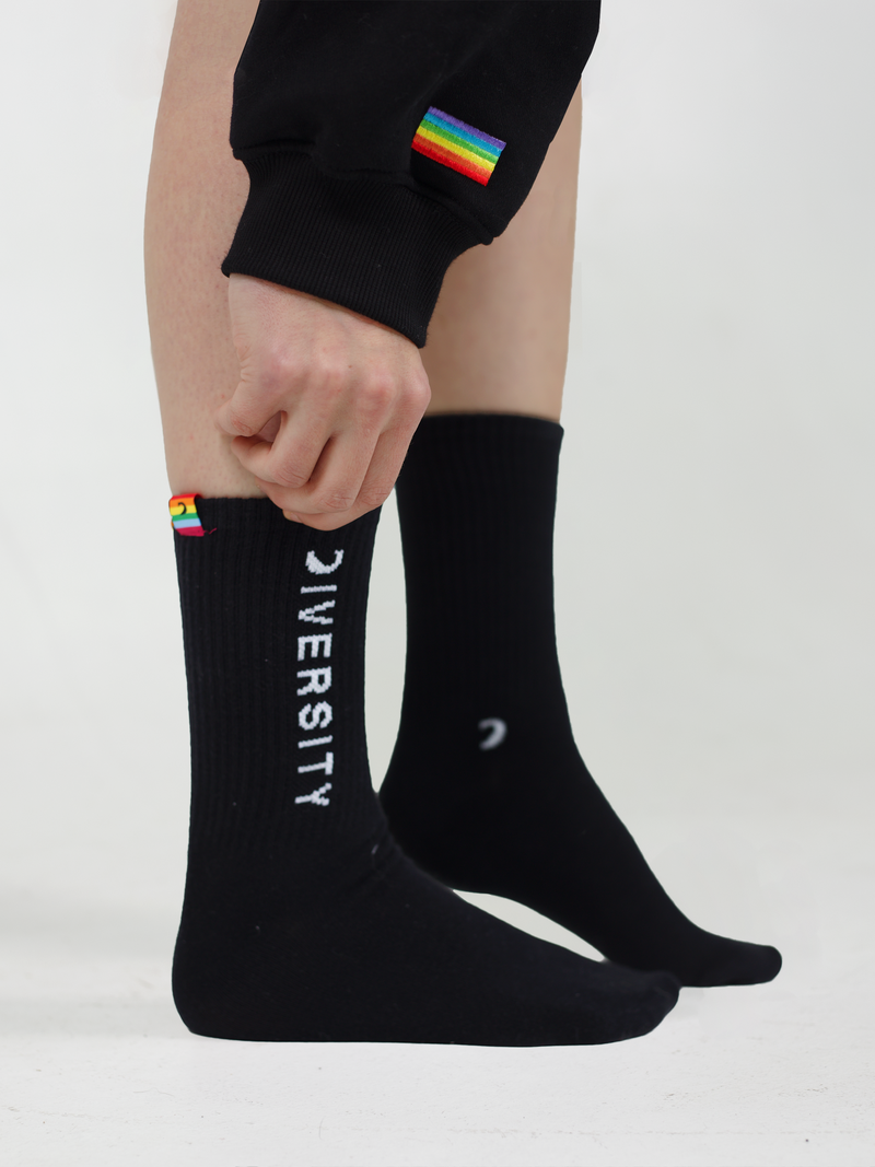Person pulling on the black Diversity socks